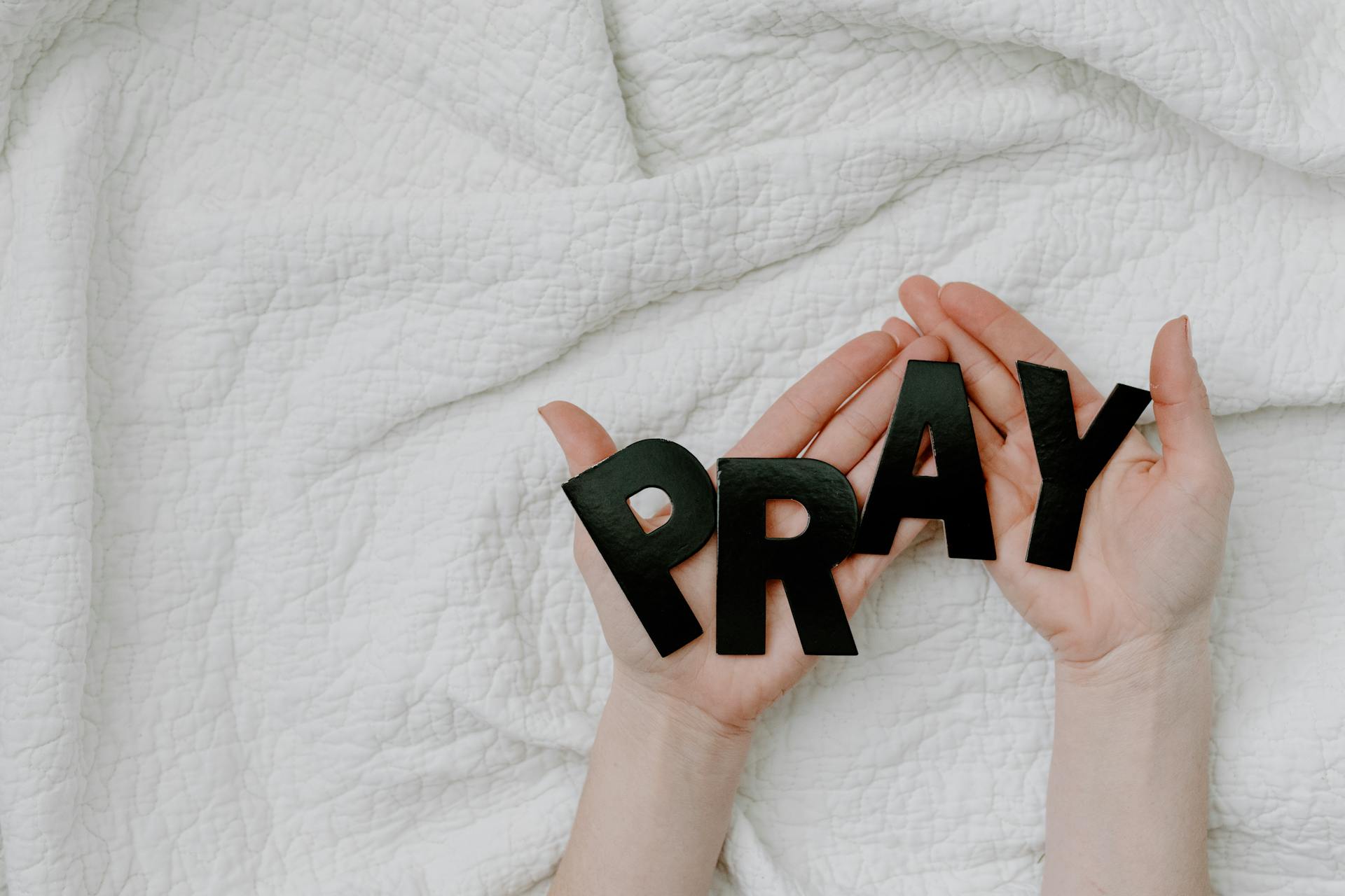 A Person Holding a Black Letters