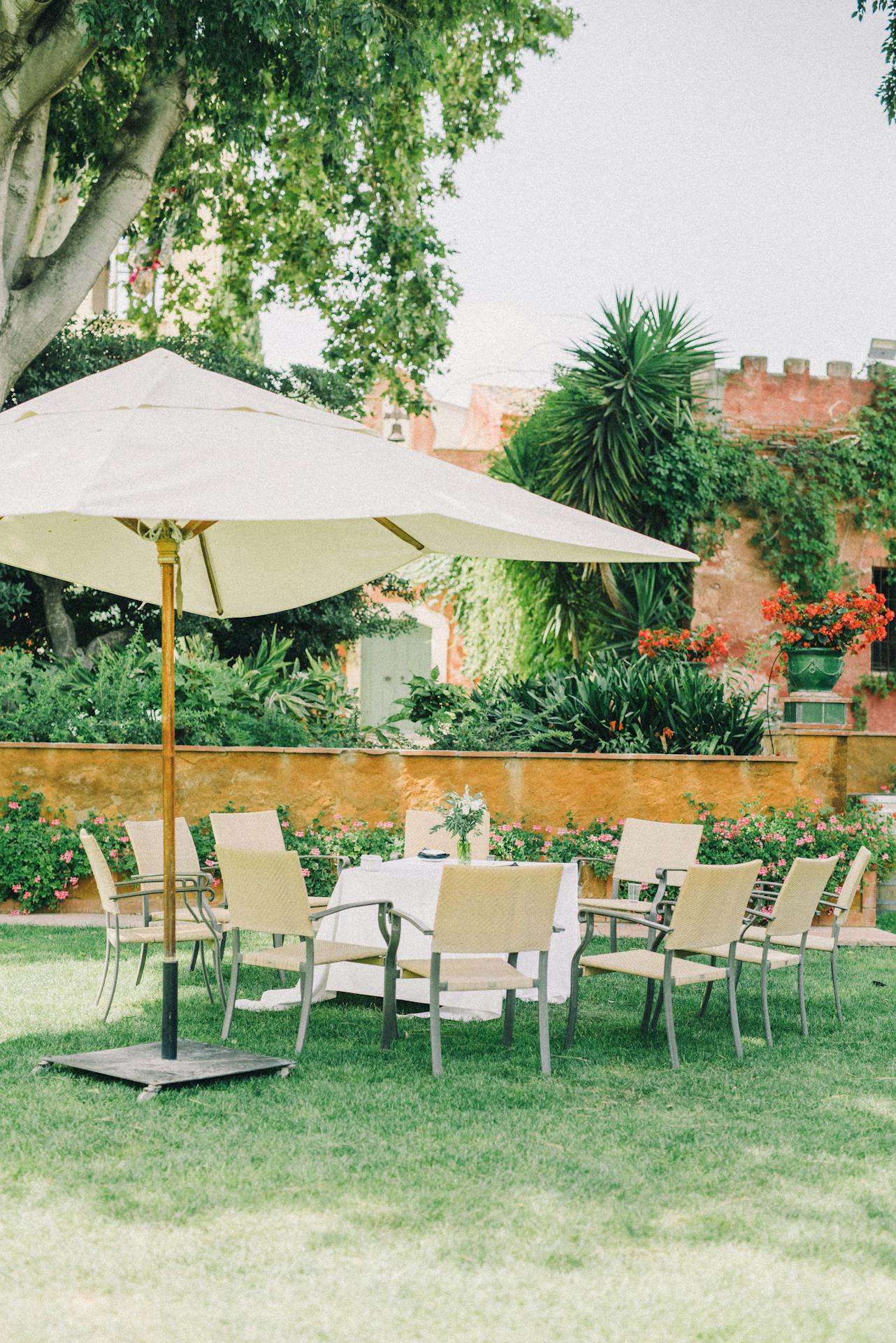 Peaceful garden patio setup with chairs and umbrella, ideal for outdoor gatherings.